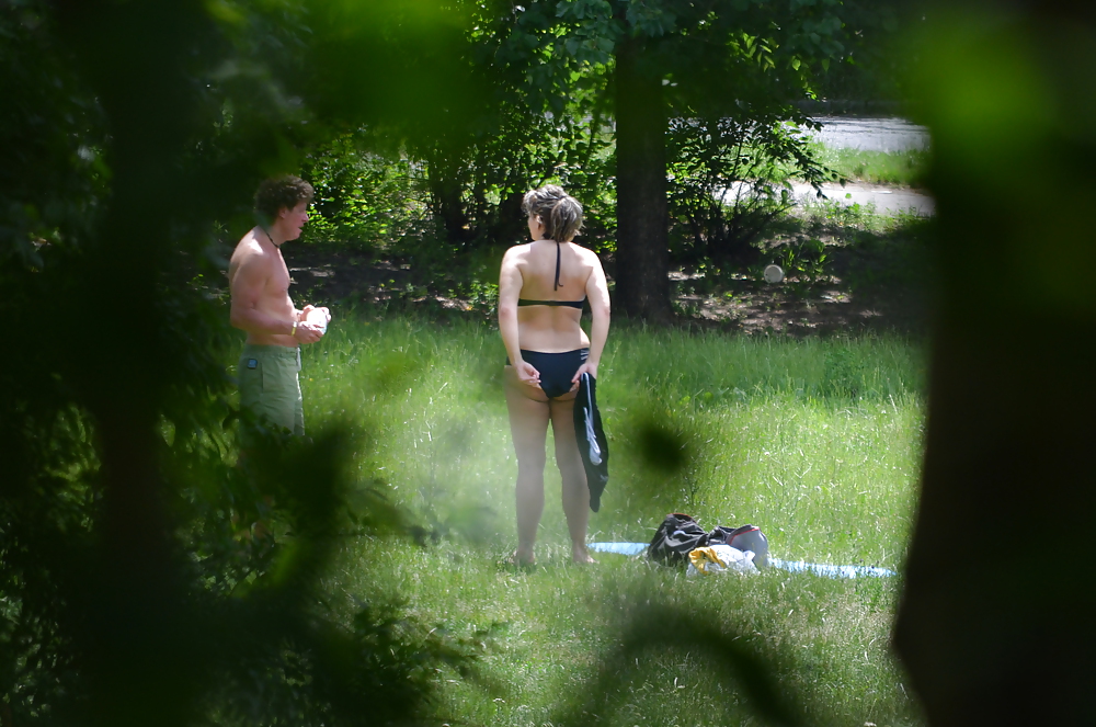 girl sunbathing in the park I adult photos