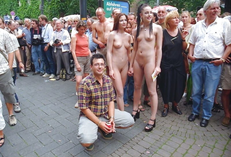 Naked sluts between clothed crowd.