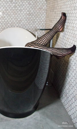 mistress black fishnets feet in bath         
