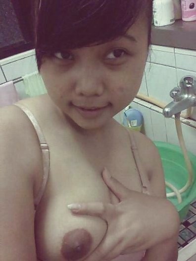 Cute Asian Chick Showing Tits adult photos