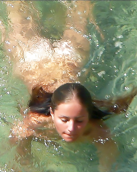 Naked girl swims at beach adult photos