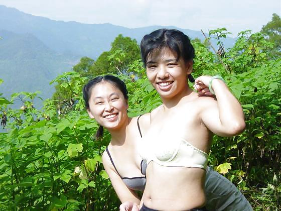 Asian girls at waterfall. adult photos