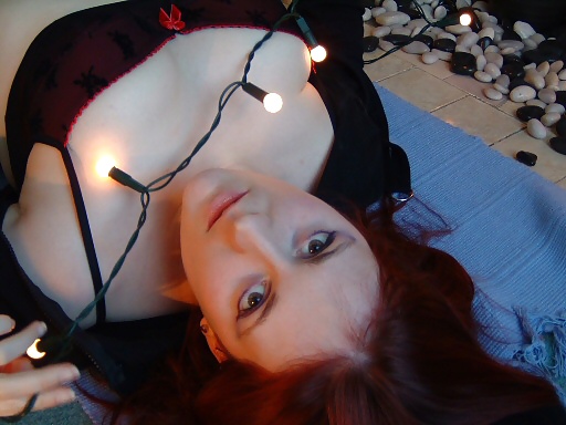 Busty Redhead Plays with Christmas Lights adult photos